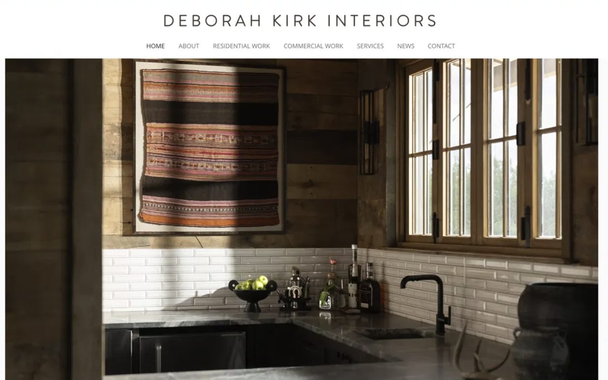 The old Deborah Kirk Interiors homepage: a plain text logo and menu above a single photo, with contact details in small type underneath